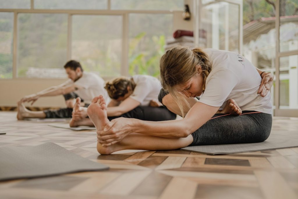 a group of people doing yoga in a room